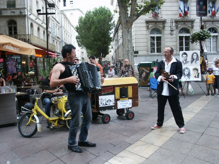 two men with a fan on a busy street