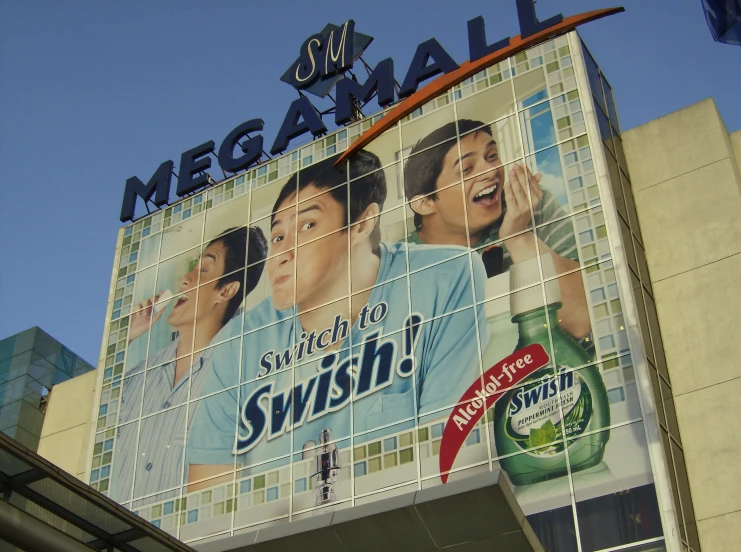 large mosaic advertit on building with woman on it