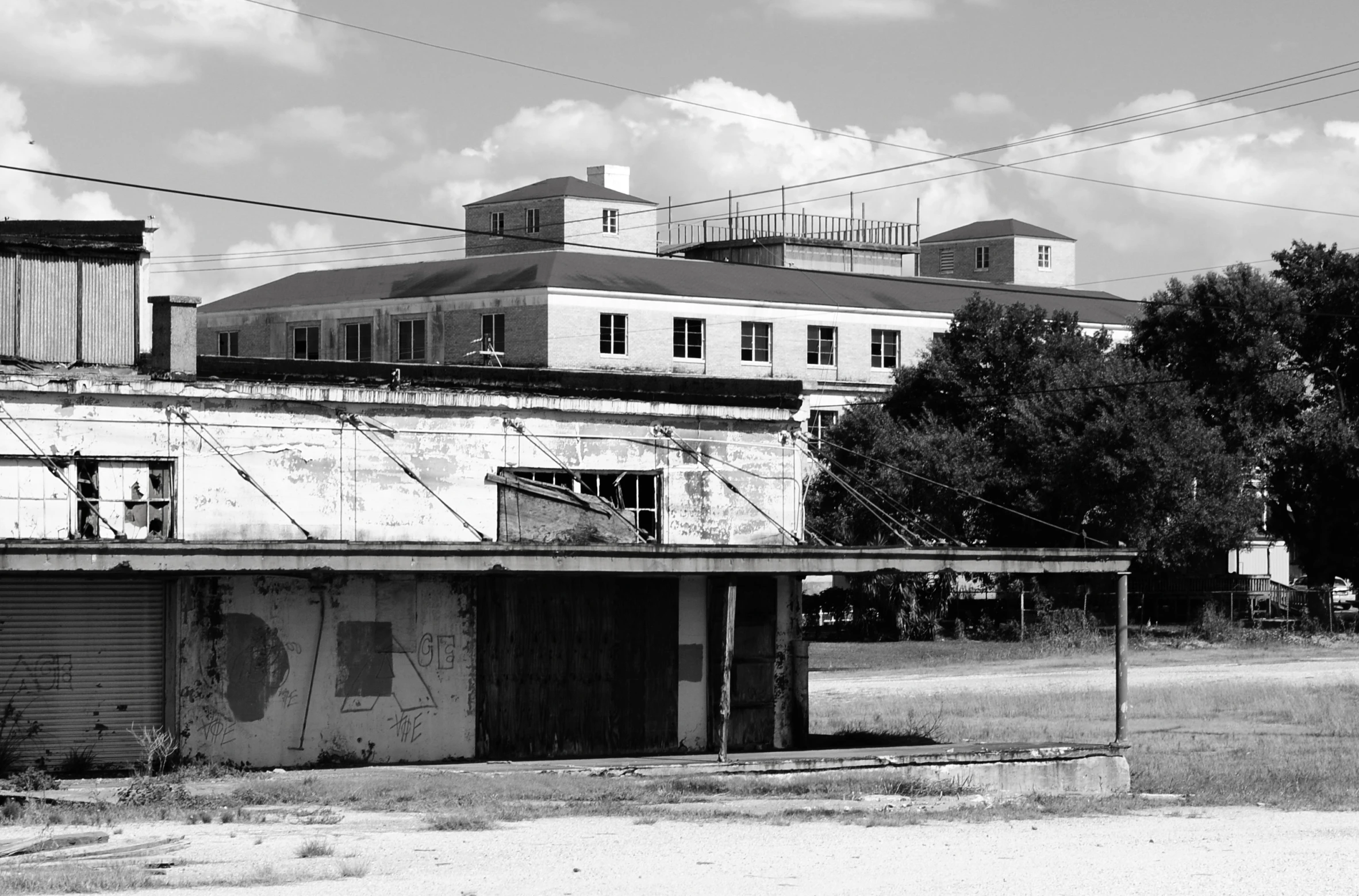 an old run down building with a fence surrounding it