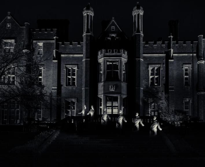 an old building with some people on it at night