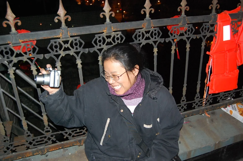 a woman taking a picture of herself with a camera