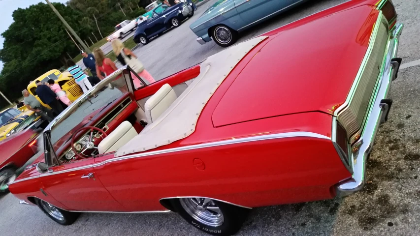 an old red car with beige interior parked