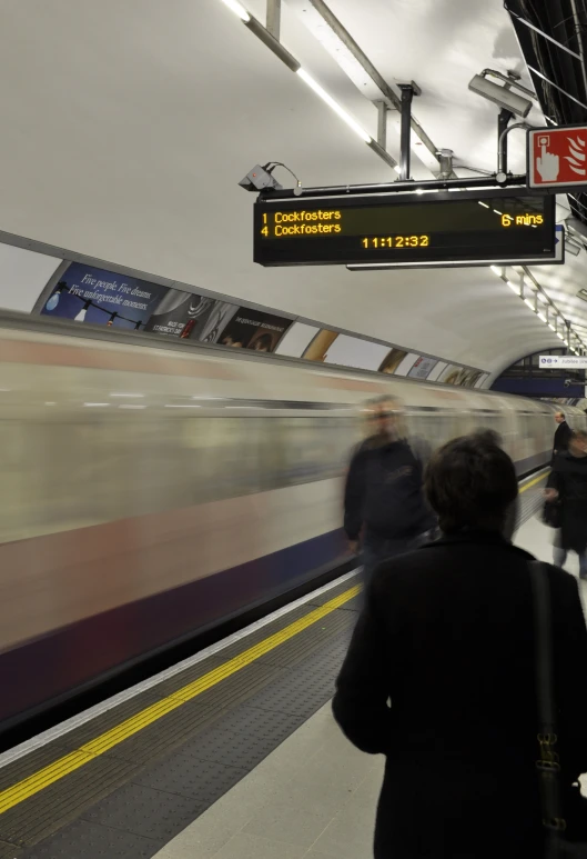 a blurry po of a person on an escalator