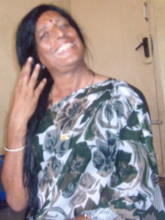 a woman talking on the phone wearing flowers in her hair