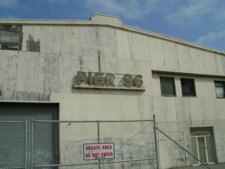 a fenced in area next to a large building