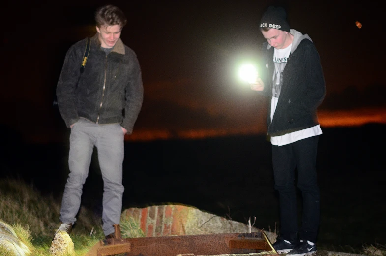 a couple of men standing on top of a wooden floor