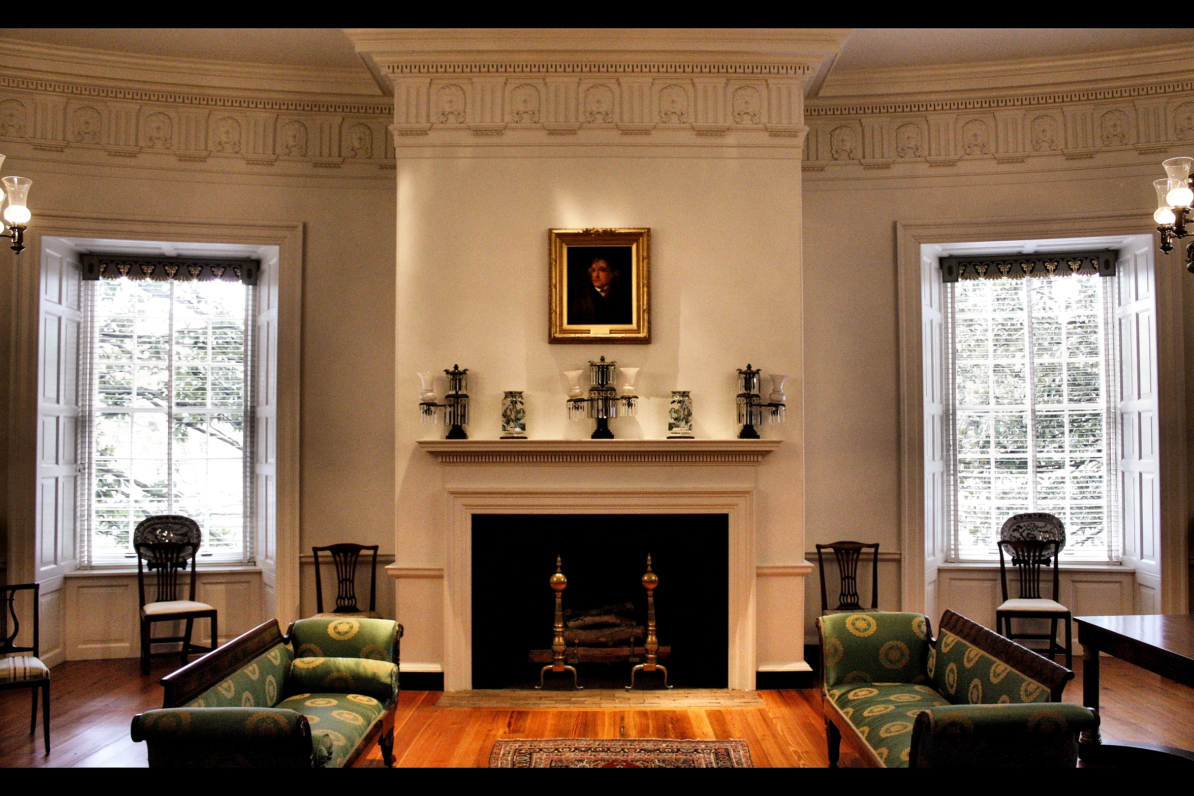 a living room with couches chairs tables and a fire place