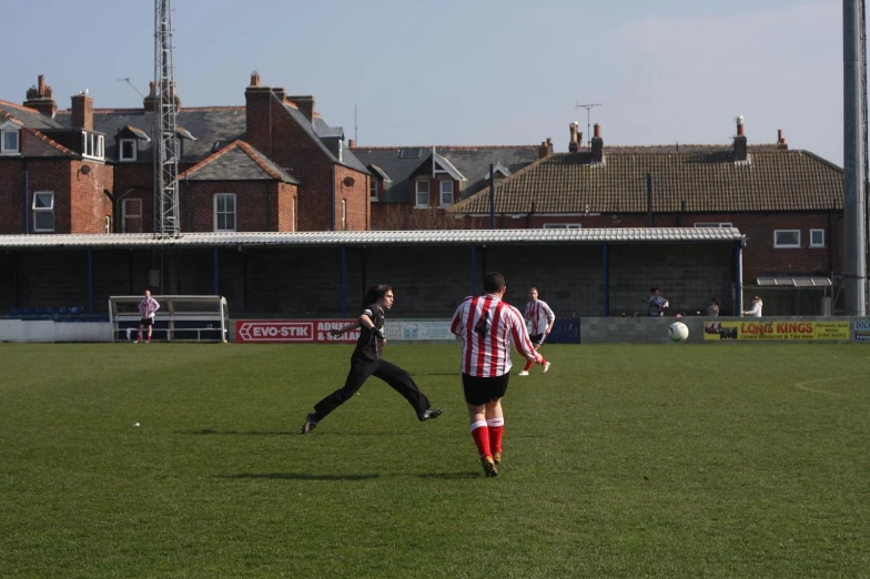 men in uniforms are playing soccer on the field