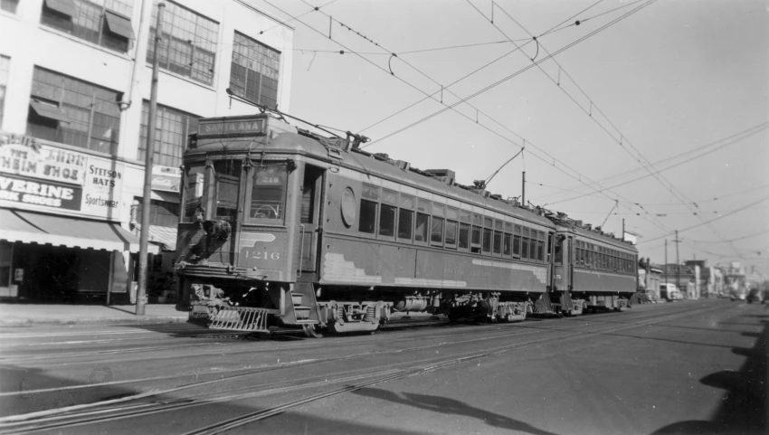 the train is going down the tracks on a hill