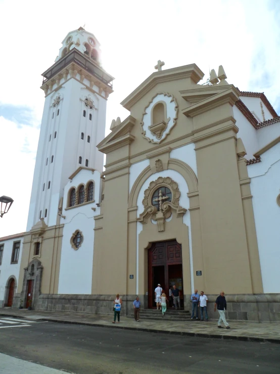 a group of people walking past a large church