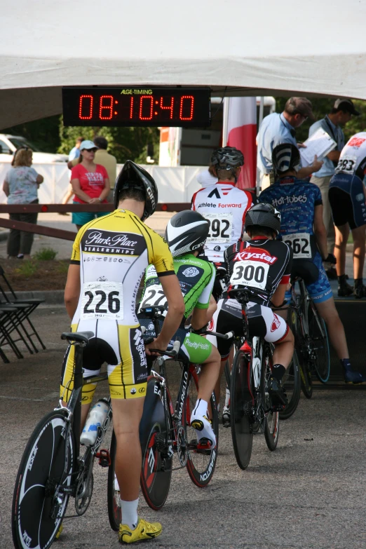 a group of boys on bikes at the finish line