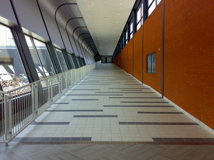 an alley way with tiled walls and metal rails