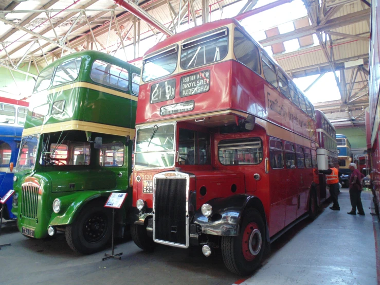 double decker buses are parked in the garage