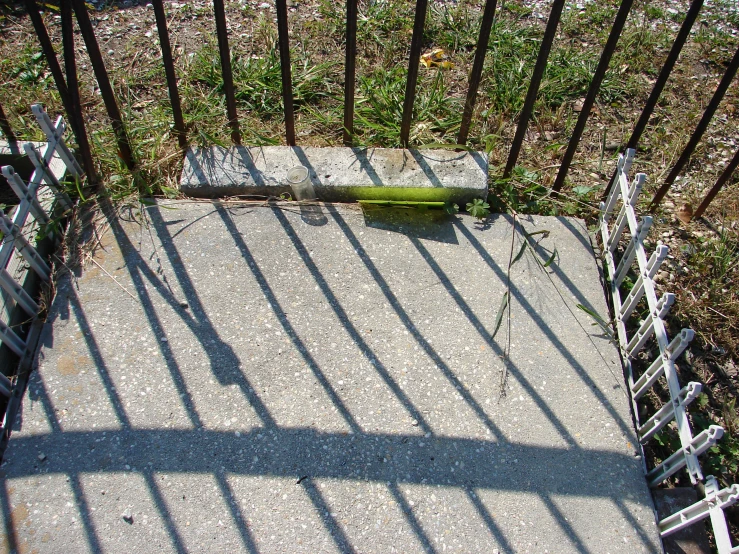 a green object sitting on top of a cement field