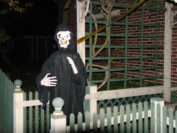 a skeleton holding up the arm of a person in a costume