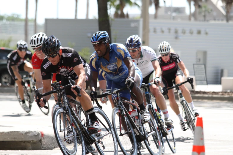 a group of cyclists racing down the street