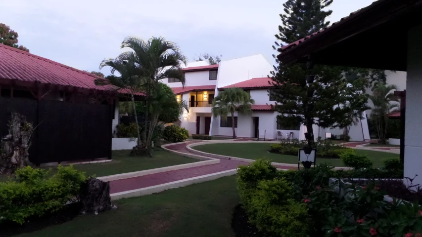 a pathway is leading to a red roofed building