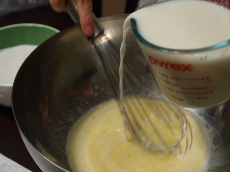 a mixing bowl filled with batter and er being poured