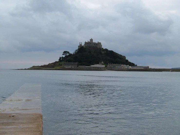 a small castle is on an island in the water