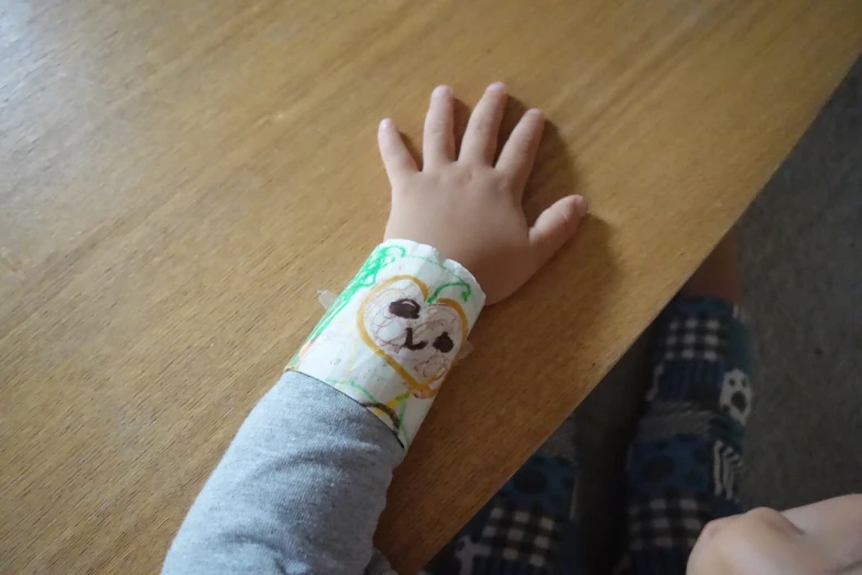 a close up of a child wearing a wrist band