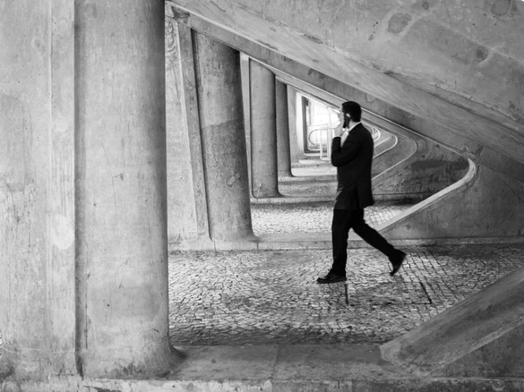 man in black walking down stairs towards camera