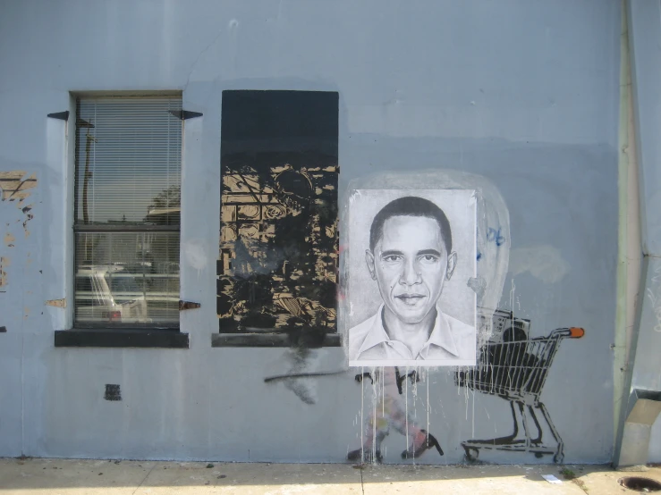 street corner painted with graffiti, a portrait and two small buildings