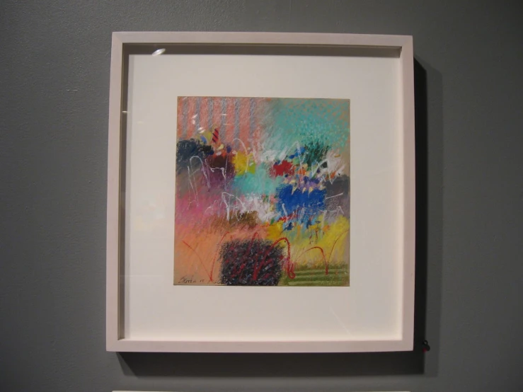 a square painting hanging up on the wall