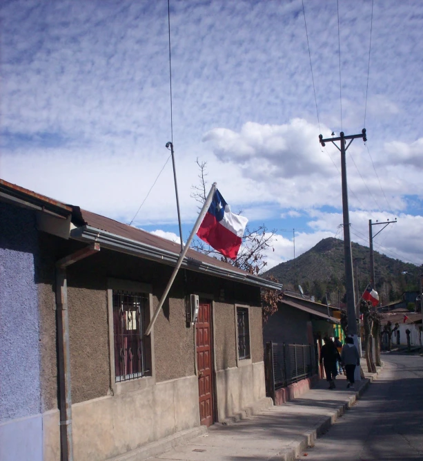 a red white and blue flag sitting on top of a building