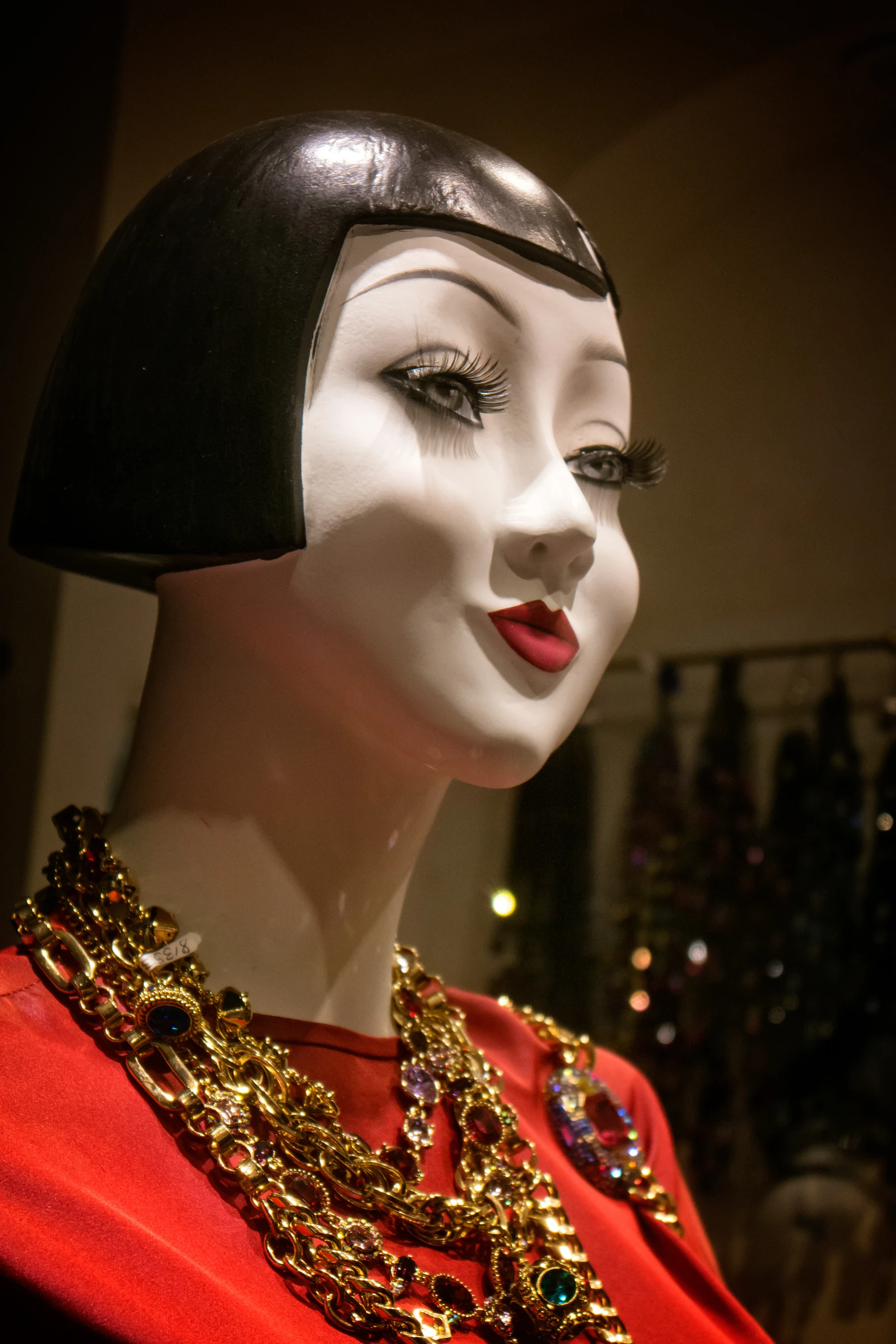 mannequin's head with gold and crystal necklaces