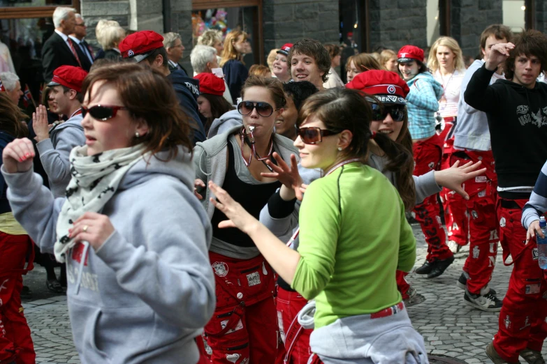 many people dressed in red and green dancing