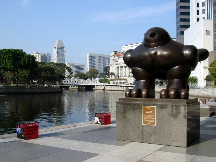 a large brown bear statue on a cement block