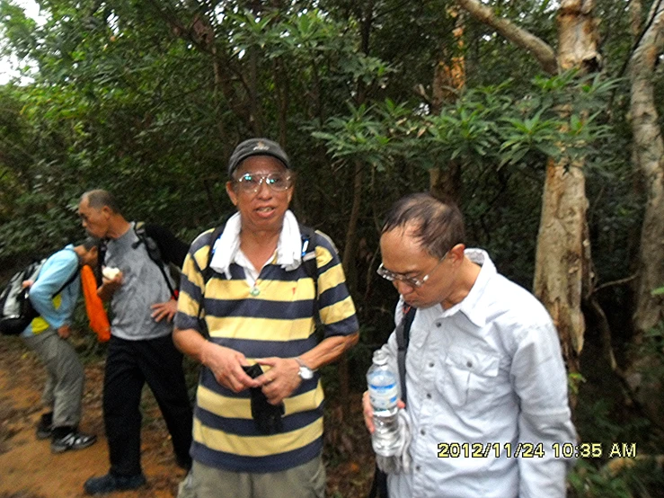 a group of people standing around on a dirt path