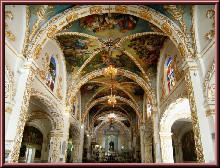 looking down the hall in an ornate cathedral with paintings on the ceiling