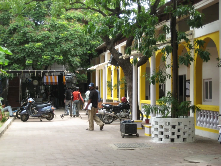 a small street with people walking around and shops on the opposite side