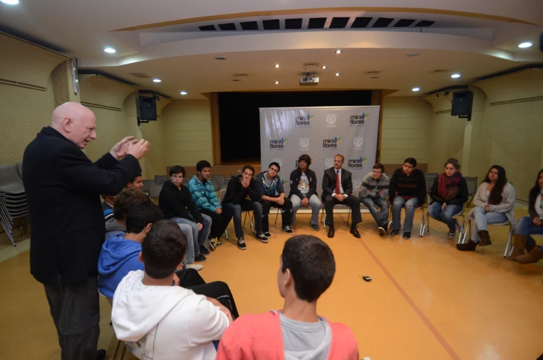 a group of people sitting in a circle listening to one another