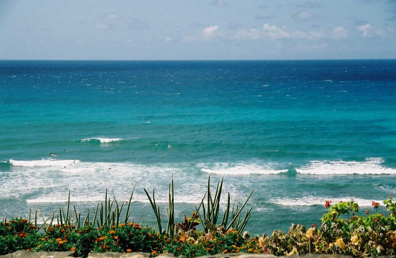 a person surfing in the ocean on a sunny day