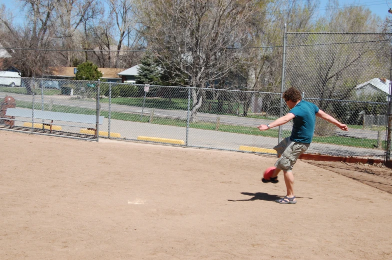 a boy is practicing his moves on his own base ball field