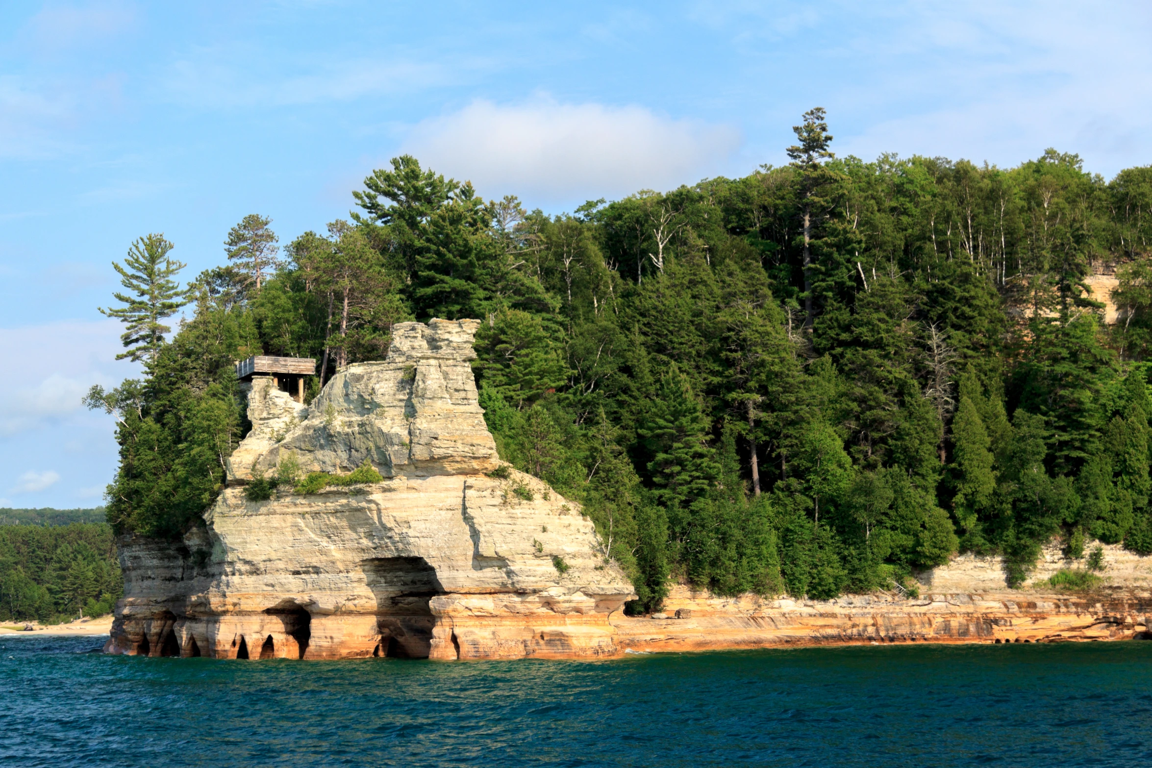 a stone cave that is by the sea