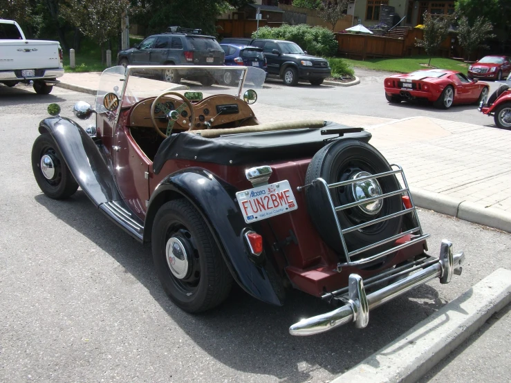 an old fashion buggy sits parked in the street