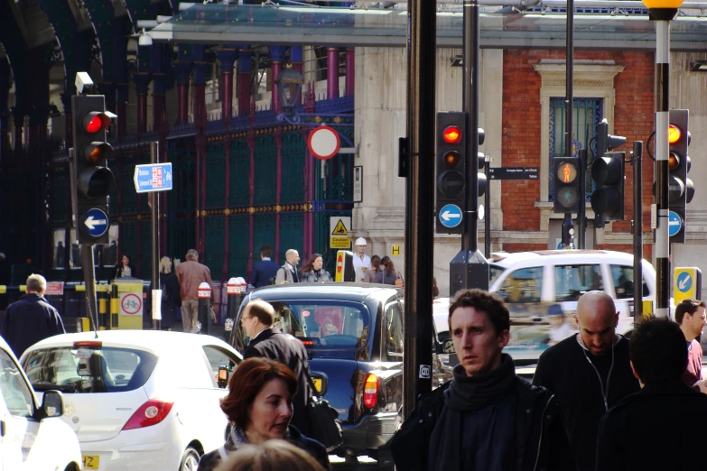 people on a city street near traffic lights