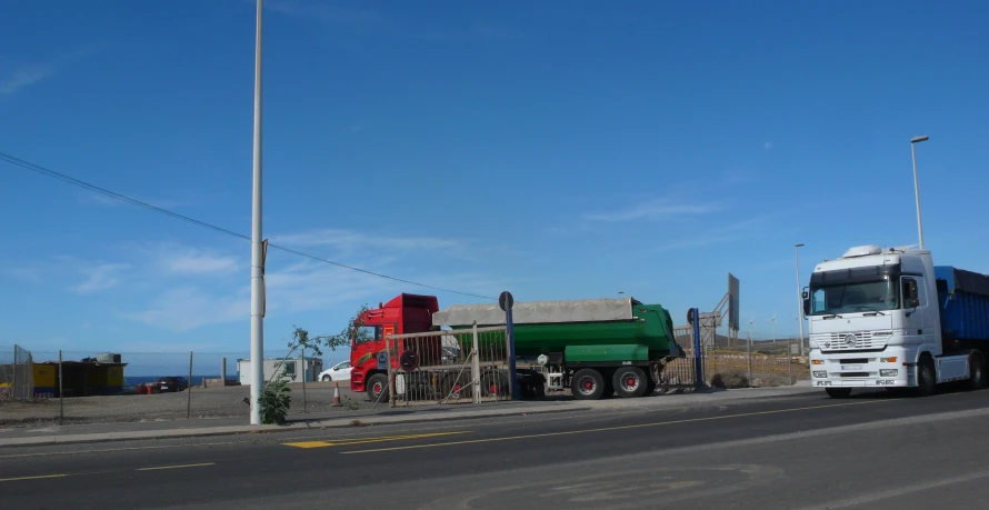 the large truck is hauling materials on a flatbed trailer