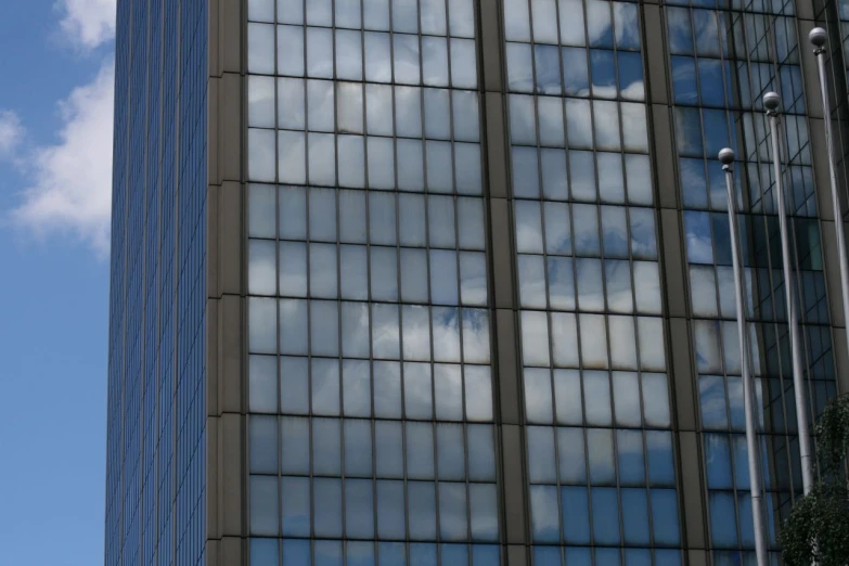 the reflection of two buildings on a glass window
