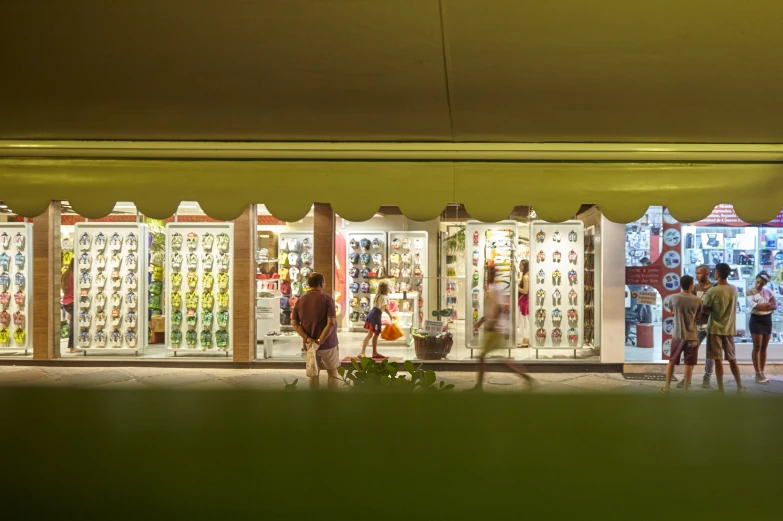 a couple people standing outside a very big store