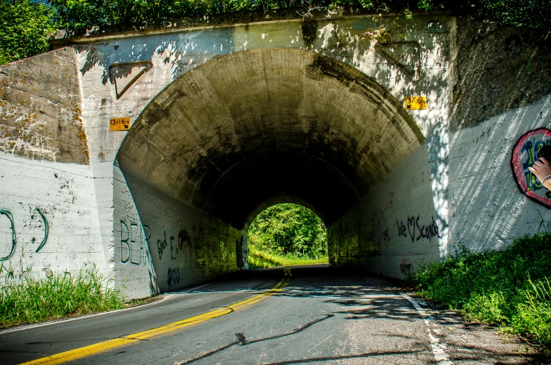 a very big tunnel with graffiti on the walls