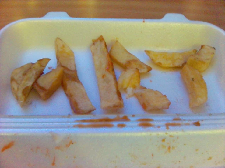 a white tray filled with fries and fruit