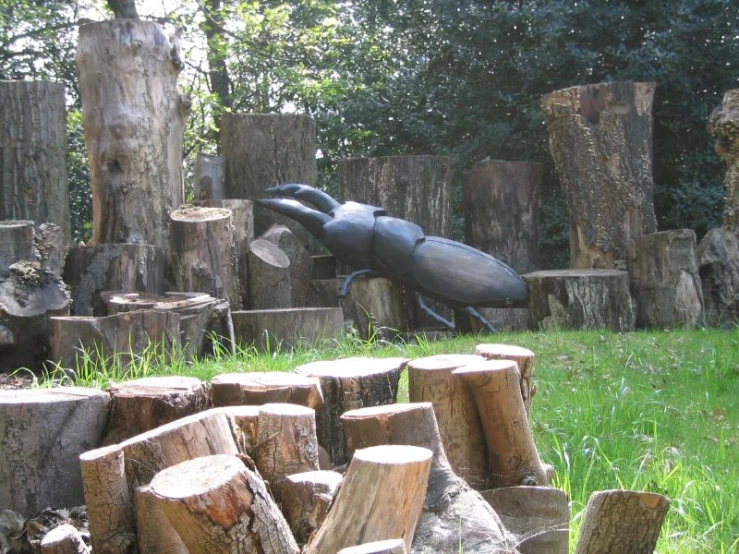 a statue of an animal jumping into a hole