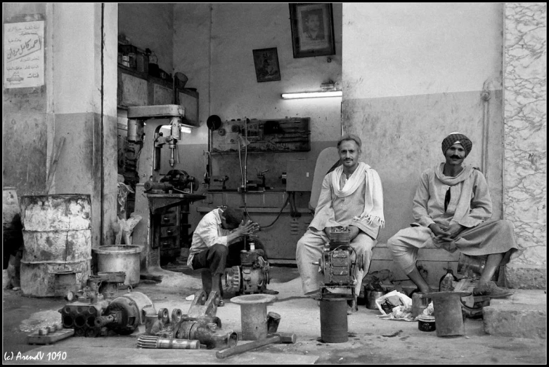 three old men in a room with many things