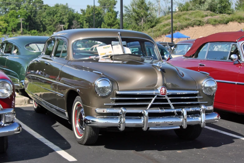 vintage cars in a parking lot at a car show