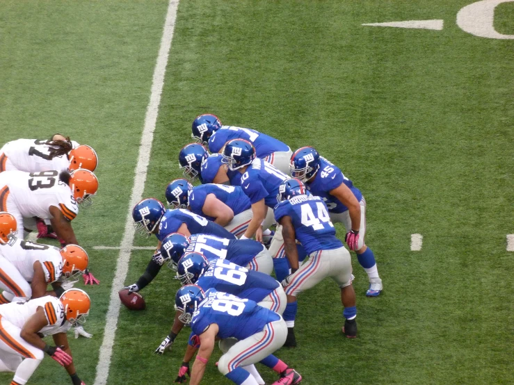 several players on different teams at the end zone of a football game