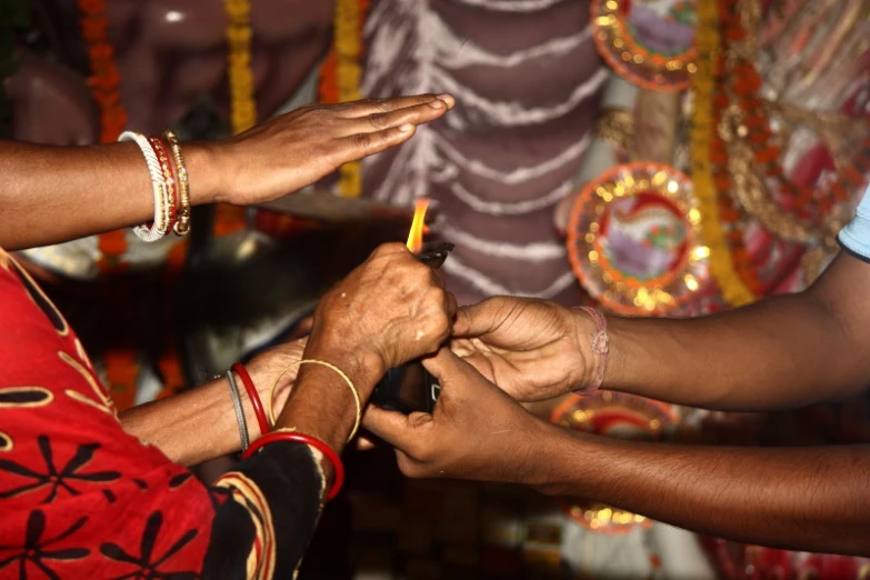 people are attending to a religious ceremony